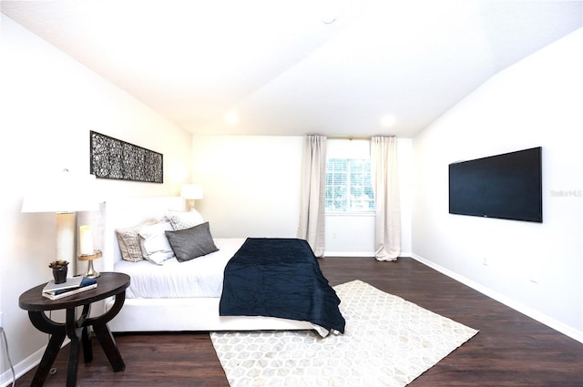 bedroom with vaulted ceiling and dark hardwood / wood-style floors