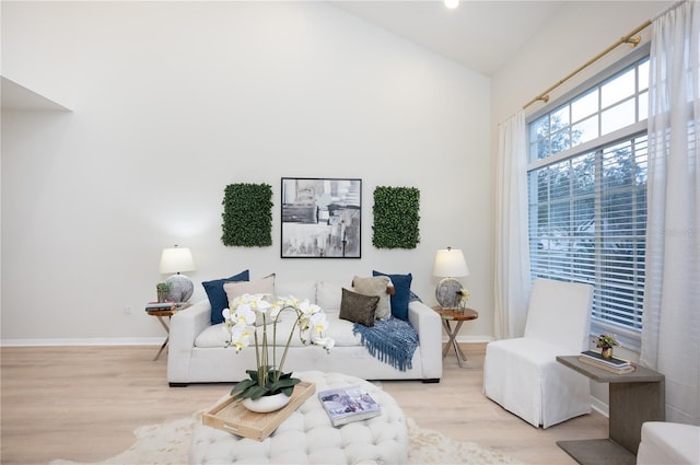 living room featuring light hardwood / wood-style floors and vaulted ceiling