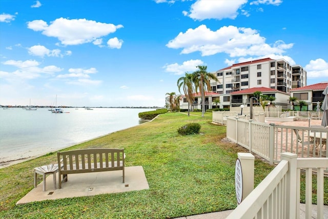 exterior space featuring a lawn and a water view