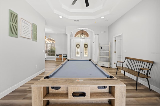 recreation room featuring billiards, hardwood / wood-style floors, a raised ceiling, french doors, and ceiling fan with notable chandelier