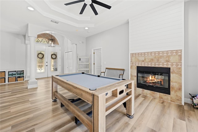 game room with light hardwood / wood-style floors, ceiling fan, a fireplace, french doors, and billiards