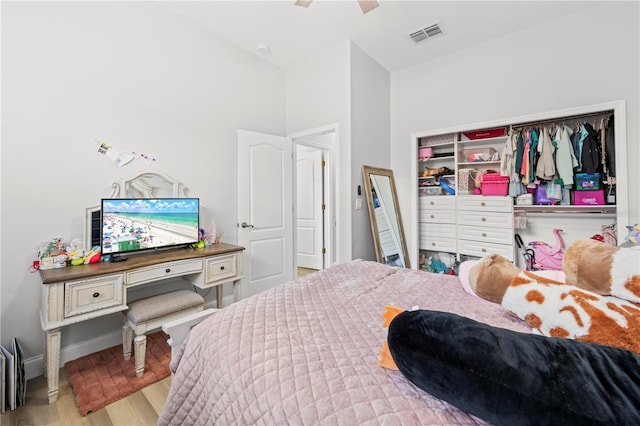 bedroom with ceiling fan, a closet, and light hardwood / wood-style flooring