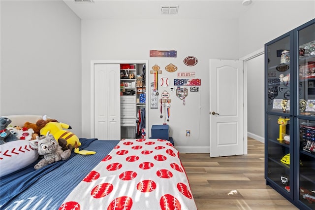 bedroom featuring hardwood / wood-style floors and a closet