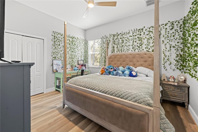 bedroom featuring ceiling fan, wood-type flooring, and a closet