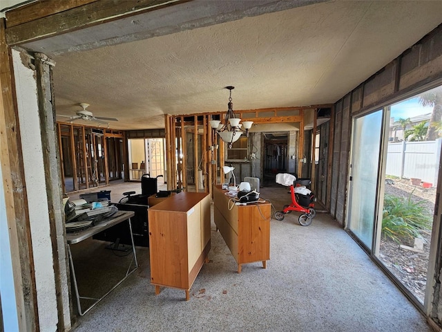 kitchen with pendant lighting and ceiling fan with notable chandelier