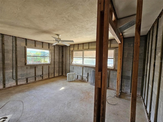 misc room with ceiling fan and a textured ceiling