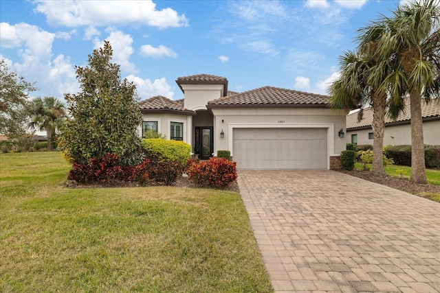 mediterranean / spanish house with a front yard and a garage