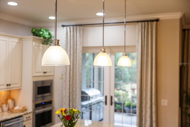 kitchen with stainless steel appliances, decorative light fixtures, crown molding, and light stone counters