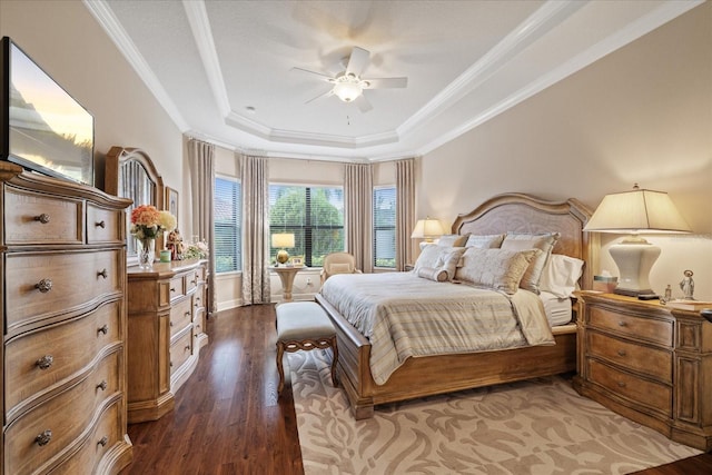 bedroom with dark hardwood / wood-style flooring, a raised ceiling, ceiling fan, and ornamental molding