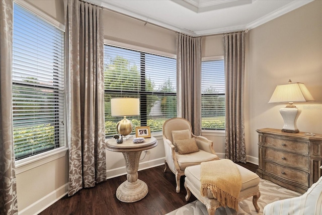 living area featuring hardwood / wood-style flooring and ornamental molding