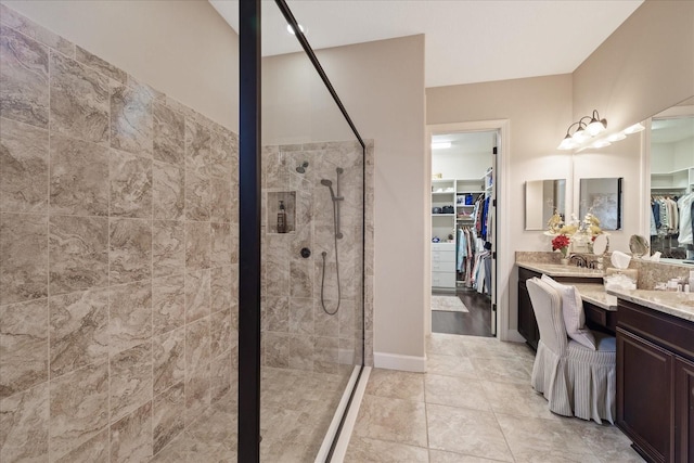 bathroom with vanity, tile patterned floors, and a shower