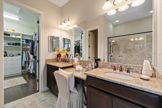 bathroom with walk in shower and vanity