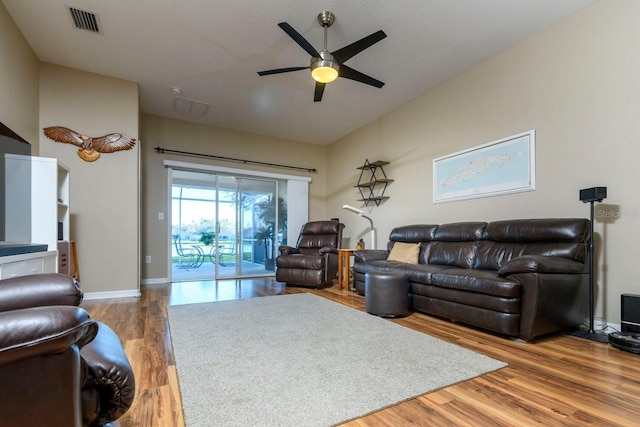 living room with ceiling fan and hardwood / wood-style floors