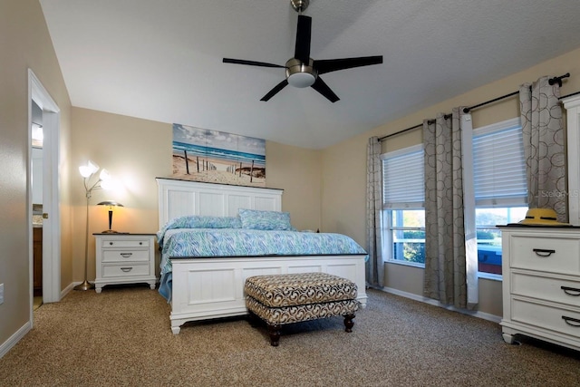 bedroom with ceiling fan, carpet, and a textured ceiling