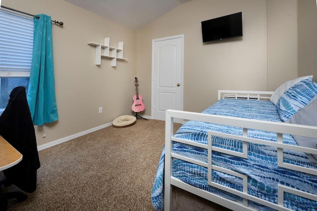 bedroom featuring carpet flooring, a textured ceiling, and vaulted ceiling