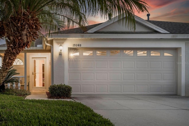 view of garage at dusk