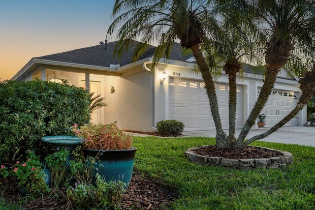 property exterior at dusk featuring a garage