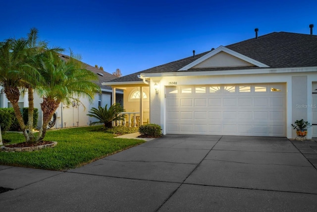 single story home with a front lawn and a garage