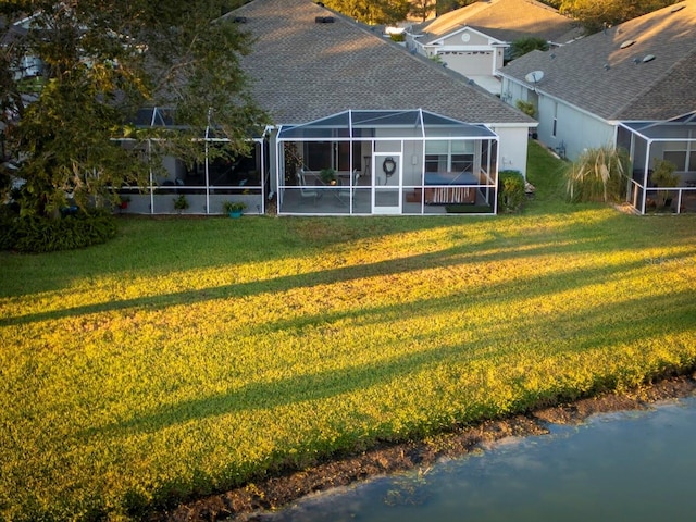 view of yard featuring a lanai and a water view