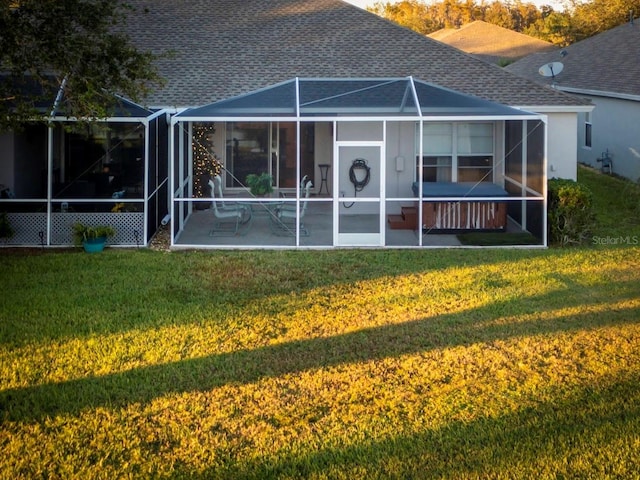 back of property featuring a lanai, a yard, and a patio area