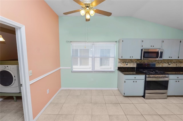 kitchen featuring washer / dryer, lofted ceiling, stainless steel appliances, backsplash, and ceiling fan