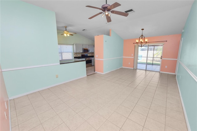 unfurnished living room with lofted ceiling, light tile patterned floors, and ceiling fan with notable chandelier