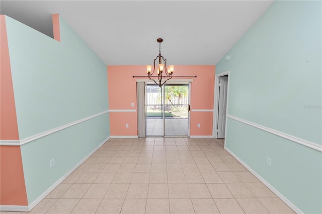 spare room featuring an inviting chandelier and lofted ceiling