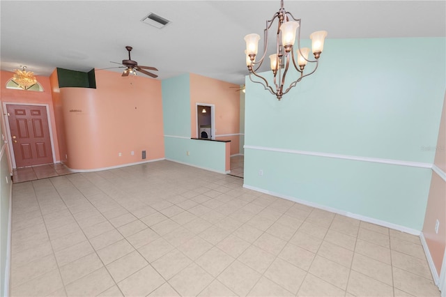 spare room with light tile patterned floors and ceiling fan with notable chandelier