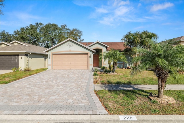 ranch-style house featuring a front yard and a garage