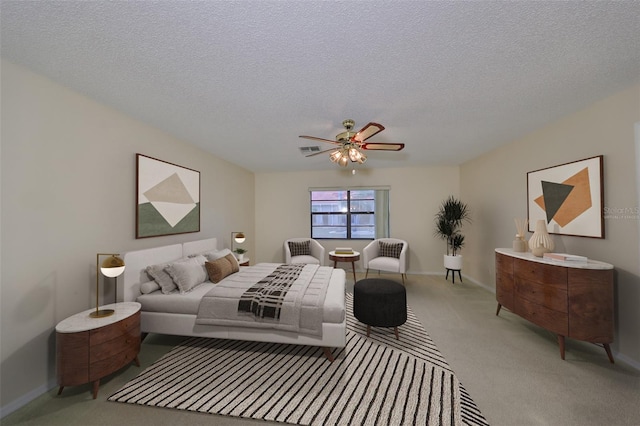 bedroom featuring a textured ceiling, ceiling fan, and carpet flooring