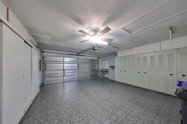 garage featuring ceiling fan and a garage door opener