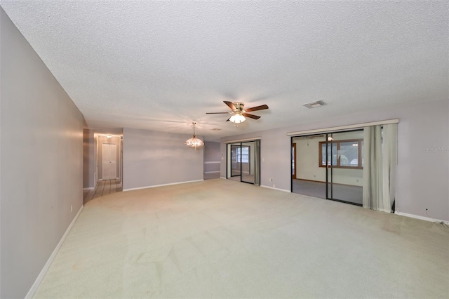 carpeted spare room featuring ceiling fan and a textured ceiling