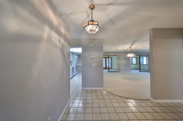 interior space featuring a textured ceiling and light tile patterned floors