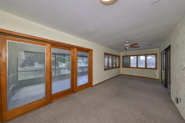 interior space featuring ceiling fan and a healthy amount of sunlight