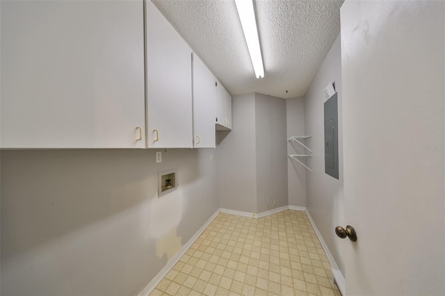 laundry area featuring washer hookup, electric panel, a textured ceiling, and cabinets