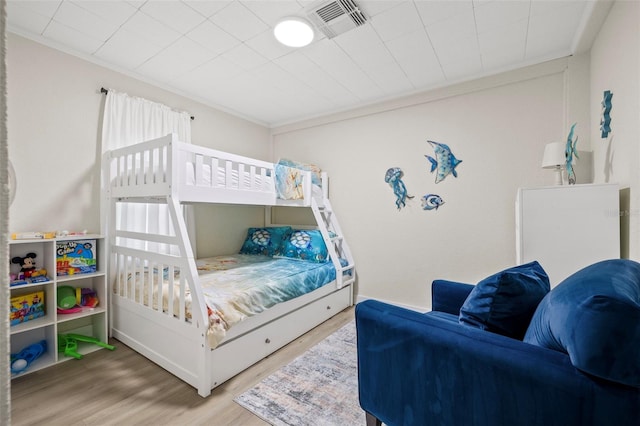 bedroom featuring crown molding and hardwood / wood-style flooring