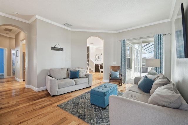 living room featuring hardwood / wood-style floors and crown molding