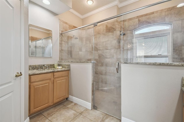 bathroom with vanity, walk in shower, tile patterned floors, and crown molding