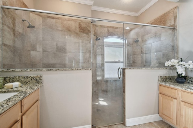 bathroom with crown molding, a shower with shower door, and vanity