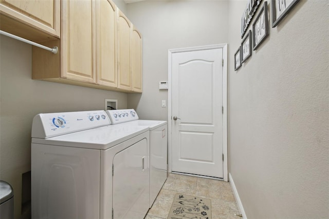 washroom with washer and clothes dryer and cabinets