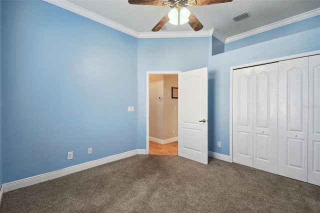 unfurnished bedroom featuring ceiling fan, ornamental molding, a closet, and carpet