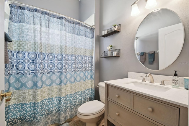 bathroom featuring toilet and vanity