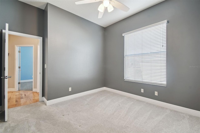 carpeted empty room featuring ceiling fan