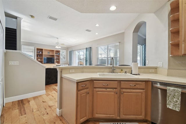 kitchen featuring dishwasher, kitchen peninsula, ceiling fan, sink, and light hardwood / wood-style flooring