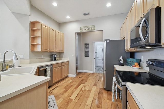 kitchen with sink, stainless steel appliances, light hardwood / wood-style floors, and light brown cabinetry