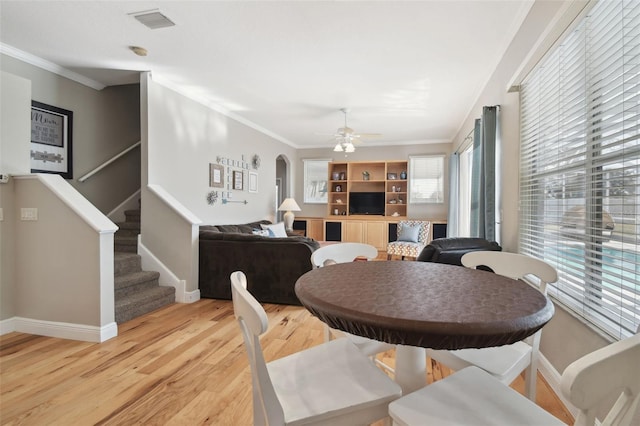 dining room featuring ceiling fan, light wood-type flooring, and ornamental molding