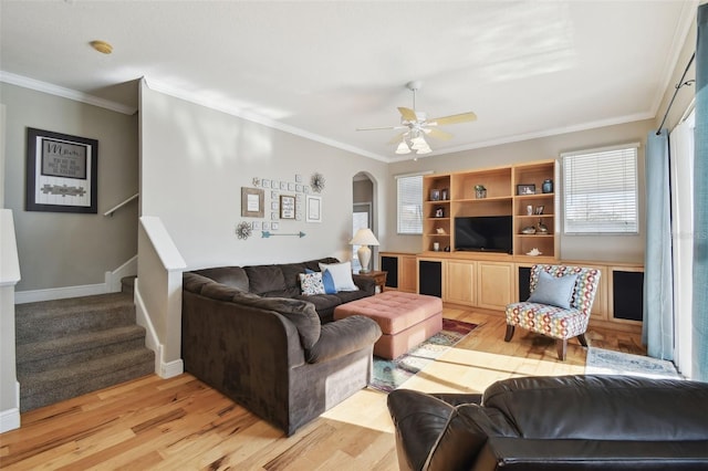 living room with ornamental molding, ceiling fan, and light hardwood / wood-style flooring