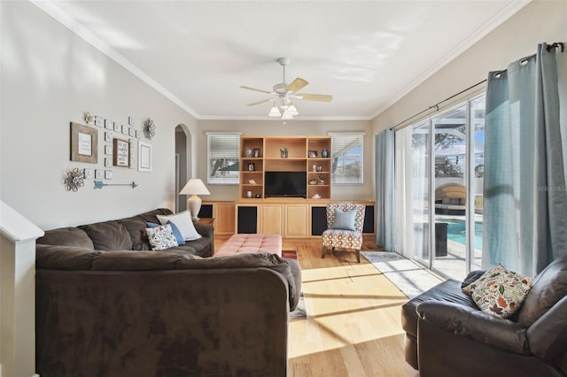 living room featuring ceiling fan, crown molding, and light hardwood / wood-style flooring