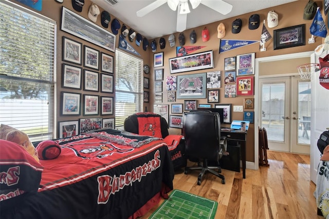 bedroom featuring ceiling fan, french doors, access to outside, and light wood-type flooring