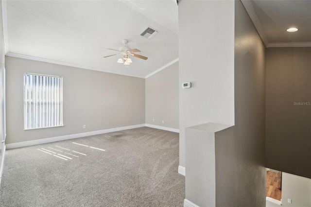 carpeted spare room featuring ceiling fan and crown molding